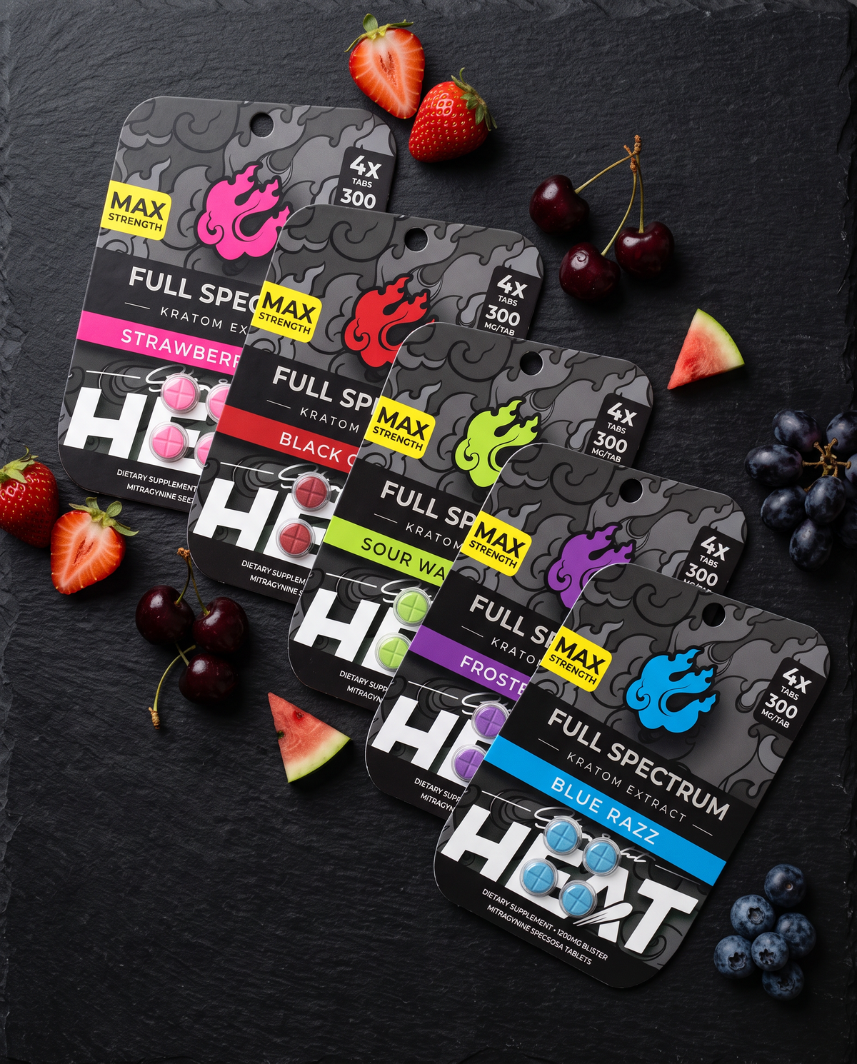 All five StraightHeat Full Spectrum tablet flavors laid out on black slate with fresh fruit