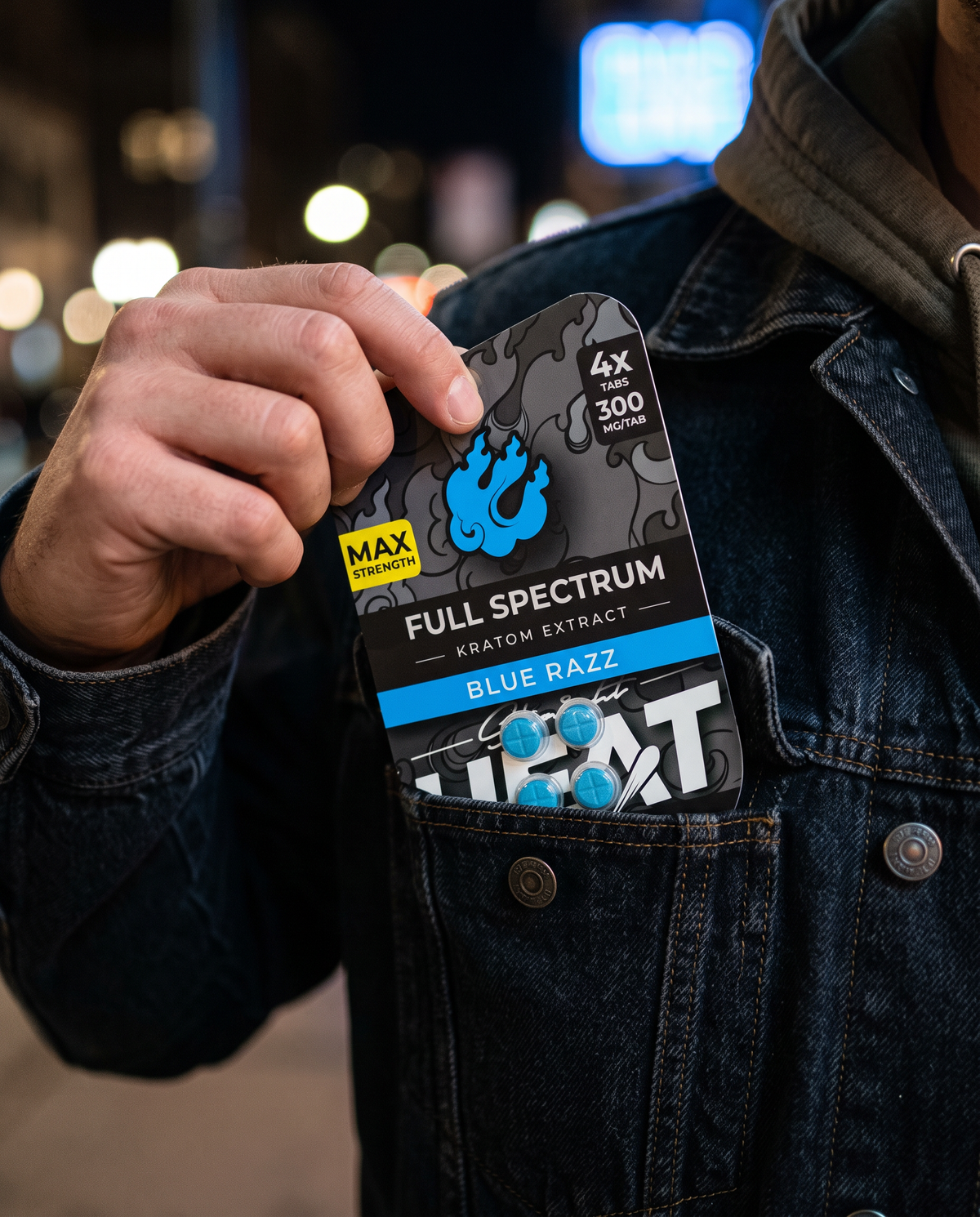 A Blue Razz tablet card pulled from a denim jacket pocket at night